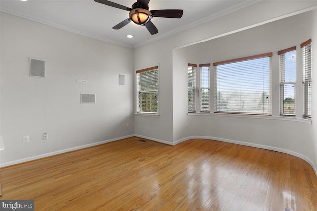 empty room featuring light hardwood / wood-style floors, crown molding, and ceiling fan