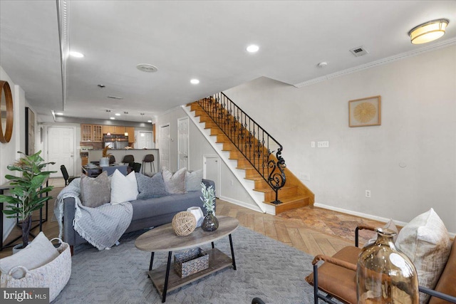 living room with crown molding and light parquet flooring