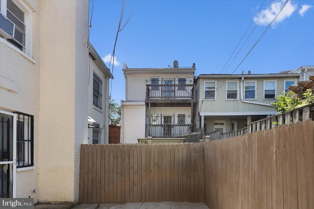 rear view of property featuring a balcony