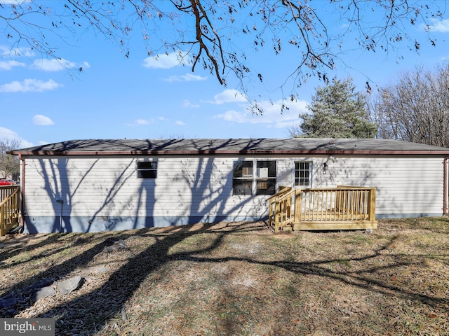 back of house featuring a deck