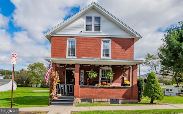 view of front of home with a porch and a front lawn