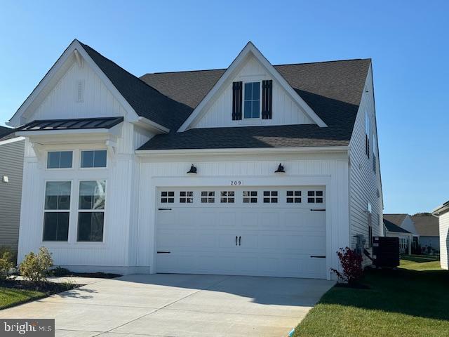 view of front of property with central AC and a garage