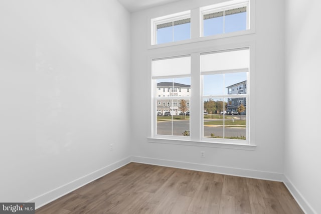 empty room with light hardwood / wood-style flooring