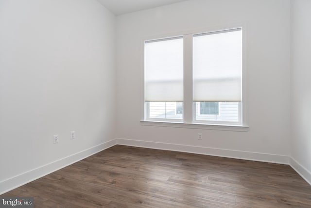 unfurnished room with dark hardwood / wood-style flooring