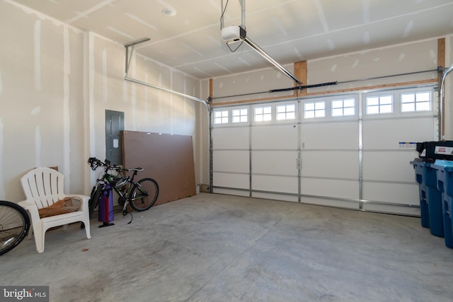 garage with a garage door opener and electric panel