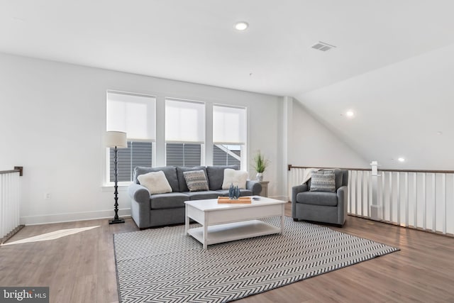 living room with vaulted ceiling and hardwood / wood-style floors