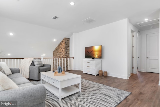 living room with lofted ceiling and dark hardwood / wood-style flooring