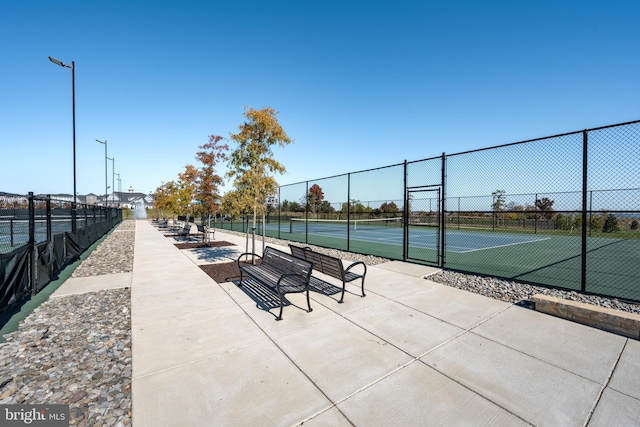 view of home's community with tennis court