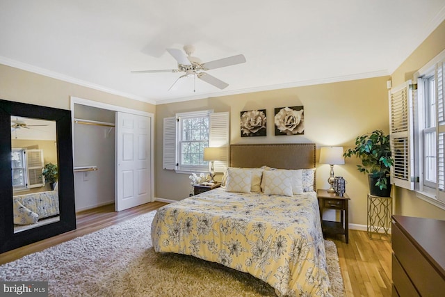 bedroom featuring a ceiling fan, crown molding, baseboards, and wood finished floors