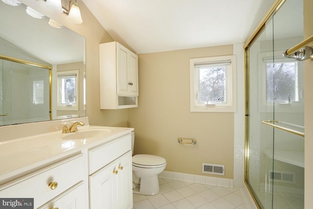 bathroom featuring baseboards, visible vents, toilet, tile patterned floors, and a shower with shower door