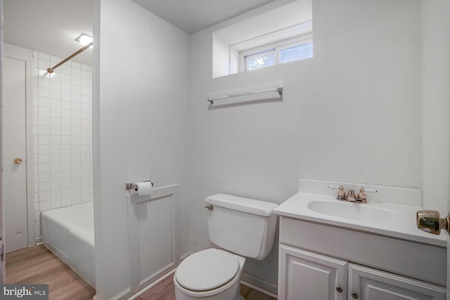 full bathroom with toilet, tub / shower combination, wood finished floors, and vanity