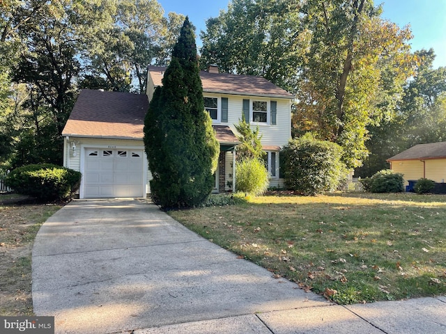 view of front of property featuring a garage and a front yard