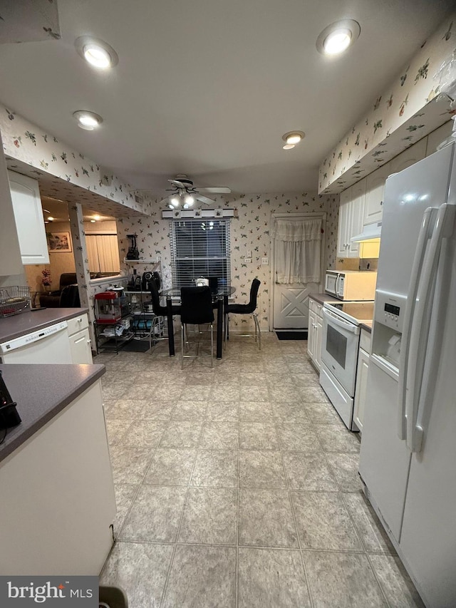 kitchen featuring ceiling fan, white cabinets, and white appliances