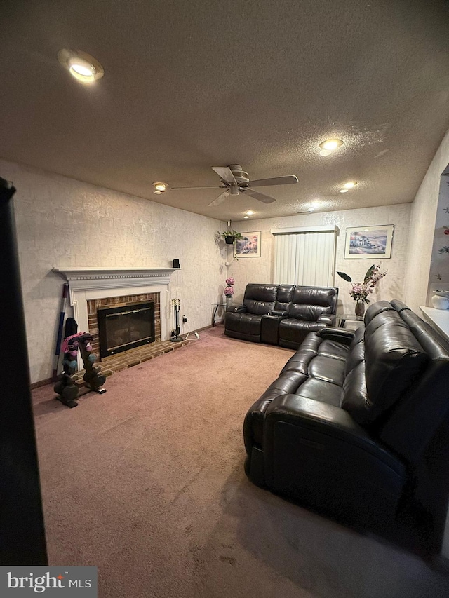 carpeted living room featuring ceiling fan, a fireplace, and a textured ceiling