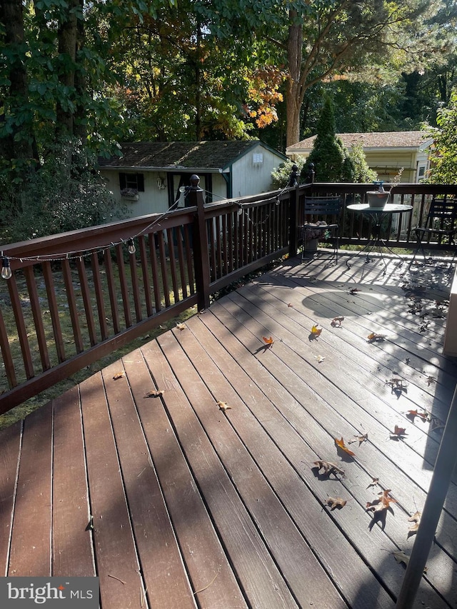 wooden terrace featuring a shed