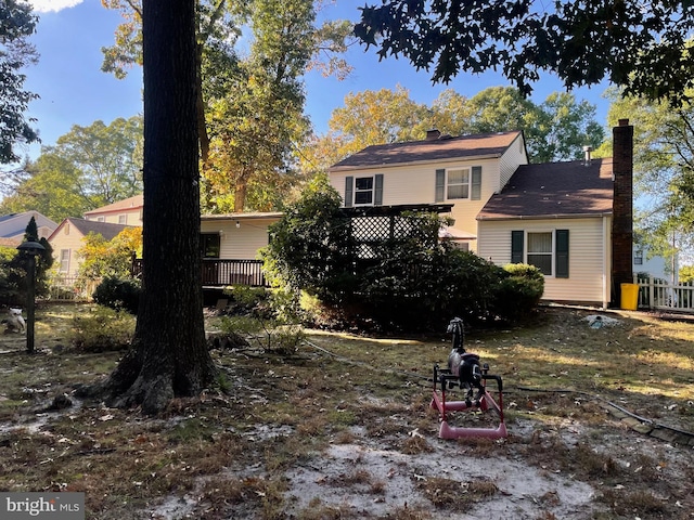 rear view of property with a wooden deck