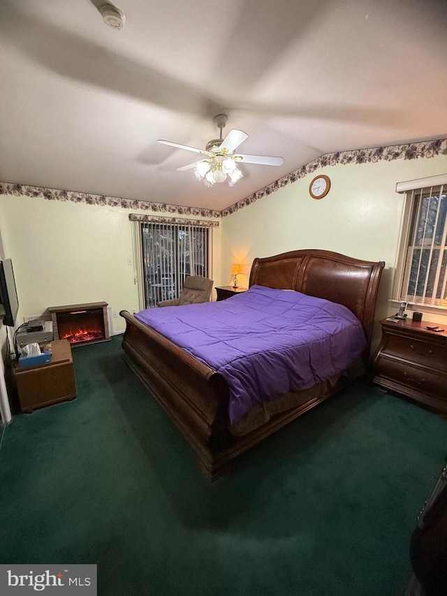 carpeted bedroom with ceiling fan and lofted ceiling