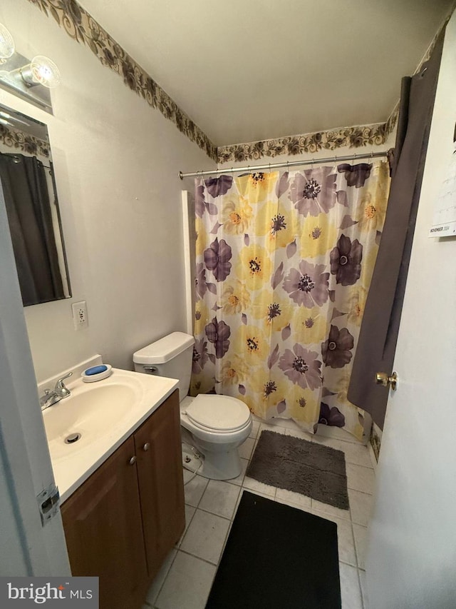 bathroom featuring tile patterned floors, vanity, and toilet