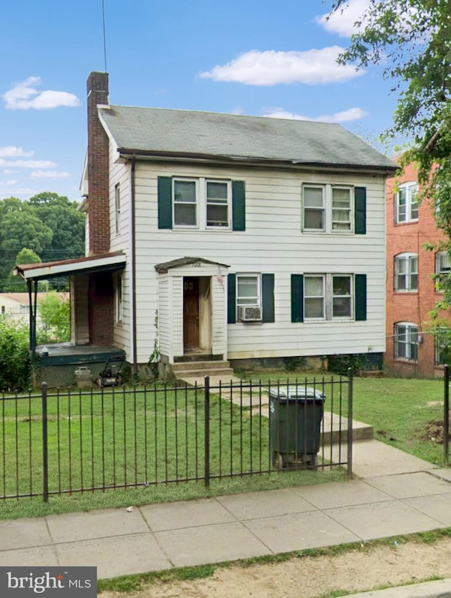 view of front of house featuring cooling unit and a front lawn