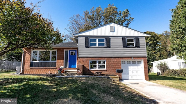 split level home with a front lawn and a garage