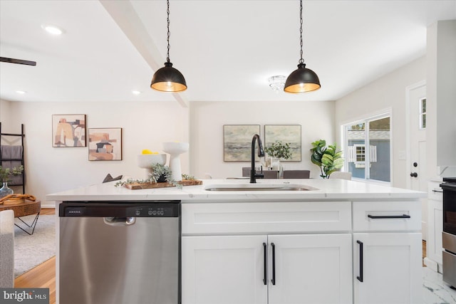 kitchen featuring sink, white cabinetry, dishwasher, and decorative light fixtures