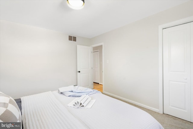 carpeted bedroom featuring a closet