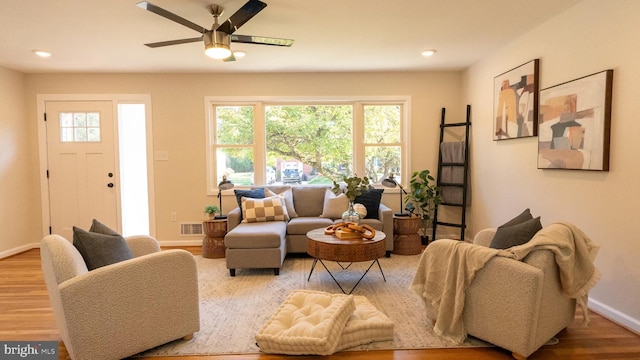 living room with ceiling fan, a healthy amount of sunlight, and hardwood / wood-style floors