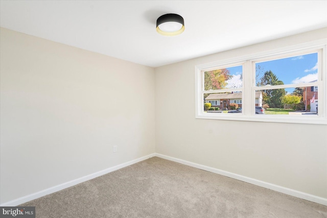 spare room with light colored carpet