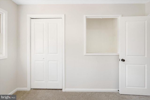 unfurnished bedroom featuring a closet and carpet floors