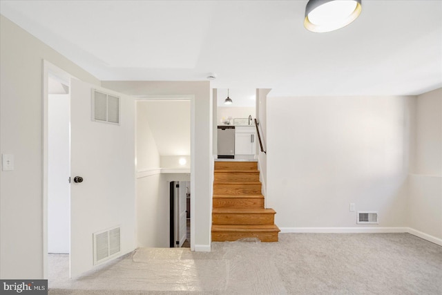 stairway with carpet floors and sink