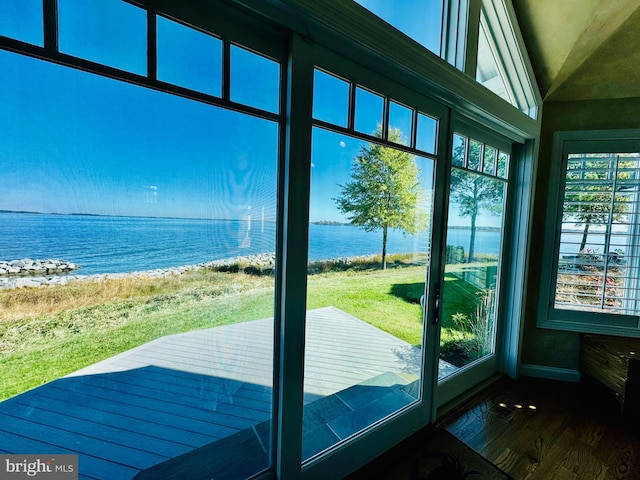 doorway with a water view and hardwood / wood-style flooring