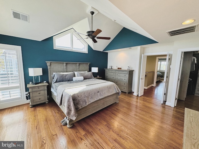 bedroom featuring ceiling fan, lofted ceiling, and hardwood / wood-style flooring