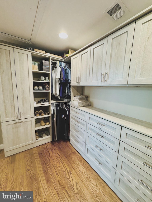 walk in closet featuring light hardwood / wood-style flooring