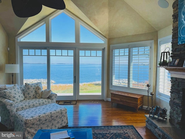 living room featuring a water view, a wealth of natural light, and dark hardwood / wood-style floors