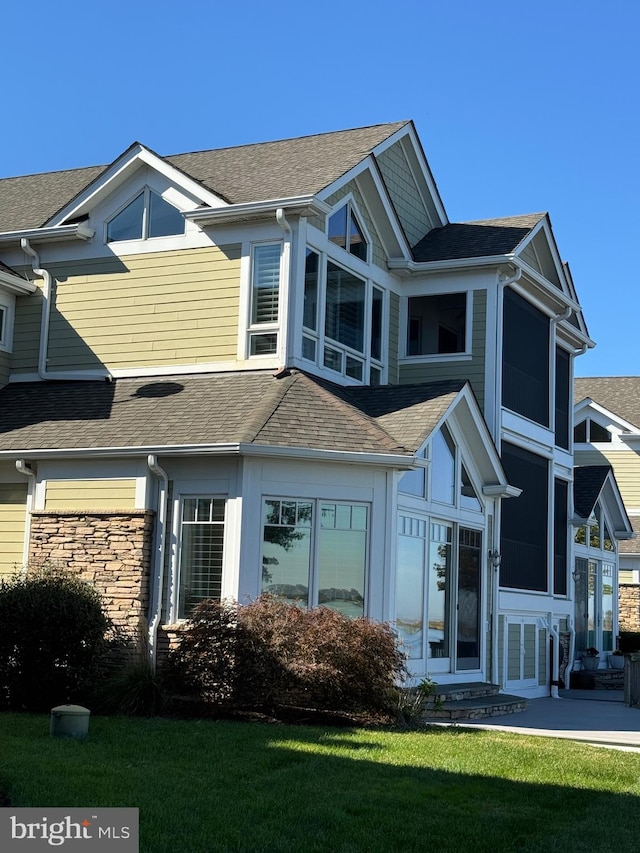 view of home's exterior featuring a lawn and a patio area