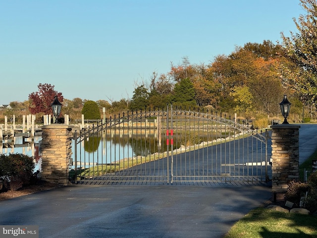 view of gate with a water view