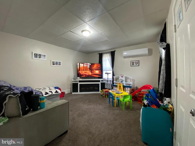 playroom featuring a wall mounted air conditioner and carpet floors