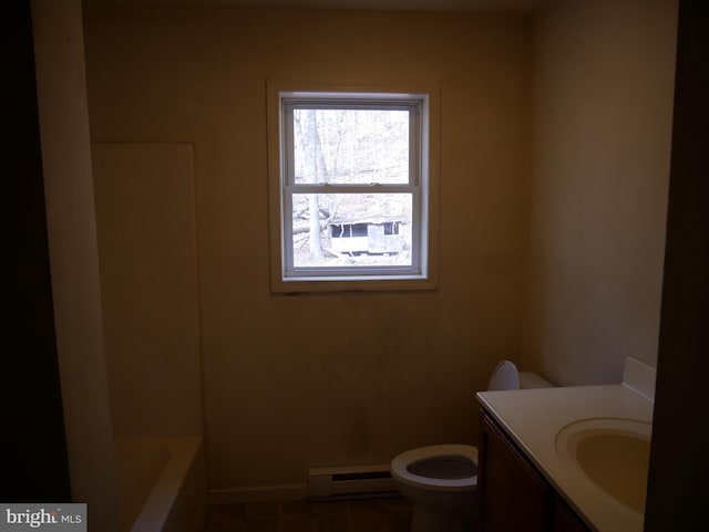 bathroom featuring vanity, a baseboard heating unit, and toilet