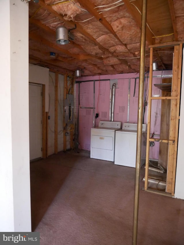 basement featuring electric panel and washing machine and dryer