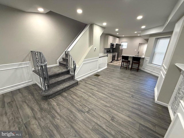 stairs featuring wood-type flooring