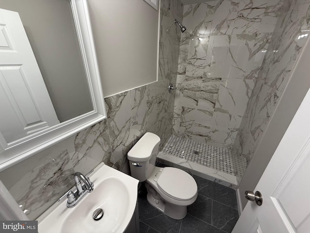 bathroom featuring sink, tile walls, tile patterned flooring, tiled shower, and toilet