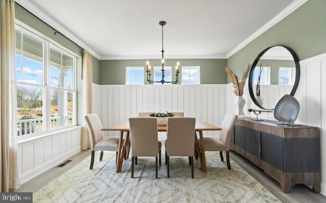 dining area with an inviting chandelier, hardwood / wood-style flooring, and a wealth of natural light