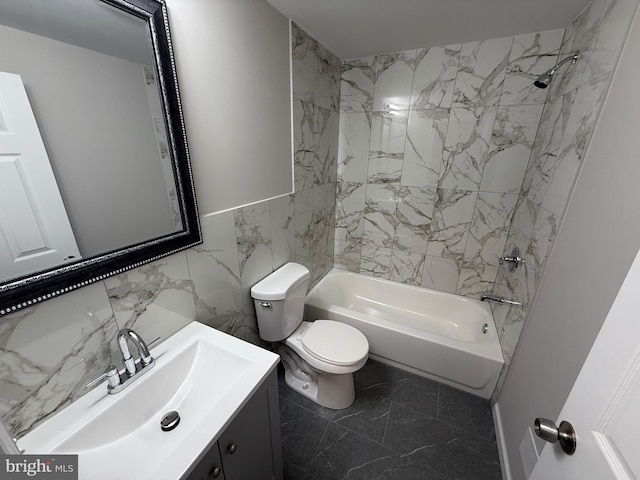 full bathroom featuring vanity, toilet, tiled shower / bath, and tile walls