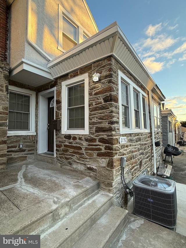 doorway to property with central AC unit