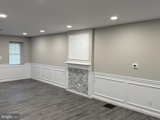 empty room with dark hardwood / wood-style flooring