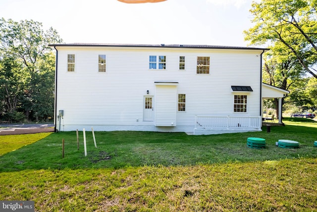 back of house with a lawn