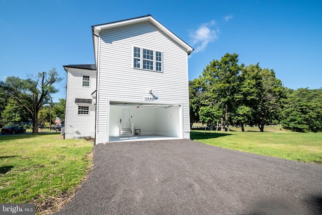 view of side of home featuring a yard and a garage