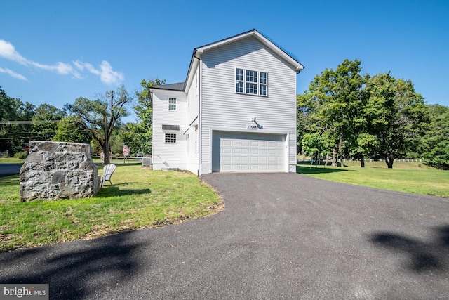 view of home's exterior with a yard and a garage