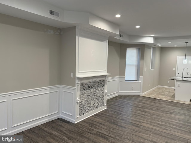 interior space with sink and dark wood-type flooring