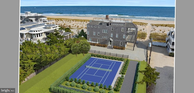 birds eye view of property featuring a beach view and a water view